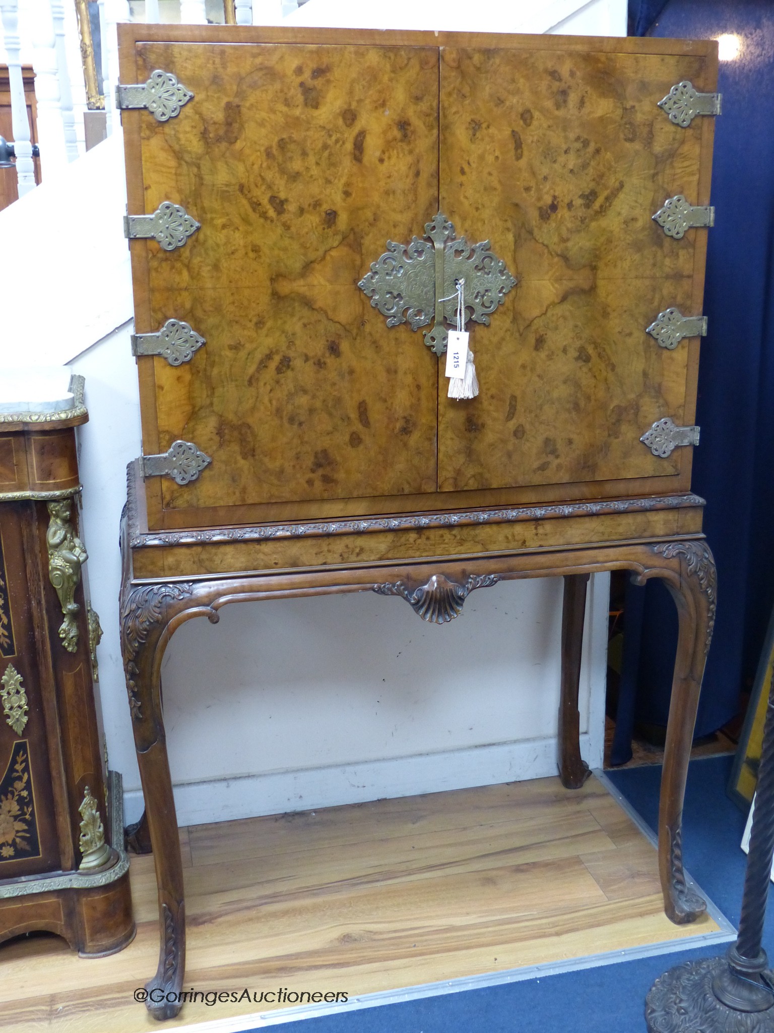 A Queen Anne style carved burr walnut cocktail cabinet on stand, width 100cm, depth 58cm, height 159cm